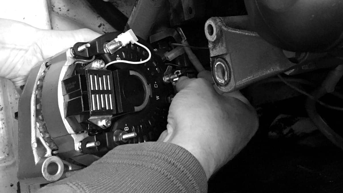 Technician repairing an alternator